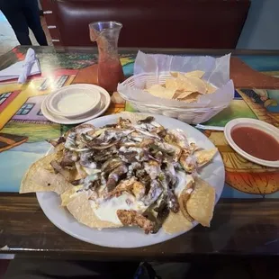 This tasty meal is steak and chicken fajita nachos. It does come with cheese on it so just remember when you order it.