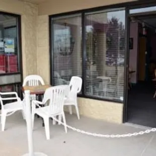 a patio with a table and chairs