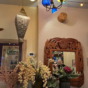 vases of flowers and a mirror