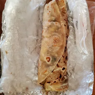 Breakfast burrito with egg, bean, bacon and potato