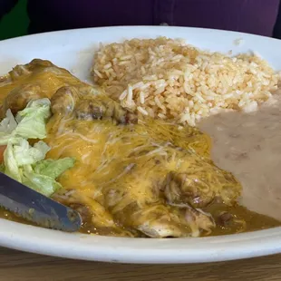 Smothered green chili burrito, rice and beans.