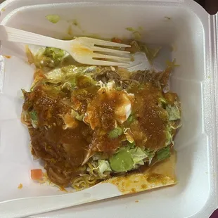 Green chili tostada covered in hot sauce