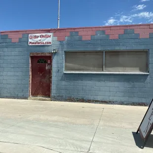 Outside. The name isn't on the building