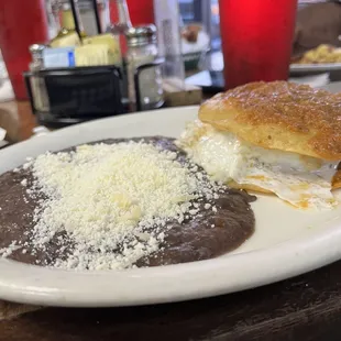 a plate of enchiladas and a pastry