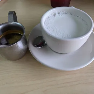a cup of coffee and a spoon on a table