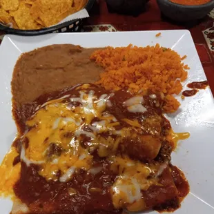 Three different enchiladas - cheese, chicken and beef with chili gravy and beans and rice. Two of their salsas with chips.