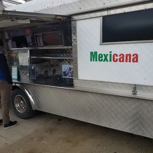 a man standing in front of a food truck