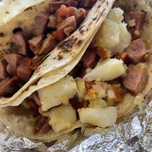 a taco with meat and potatoes