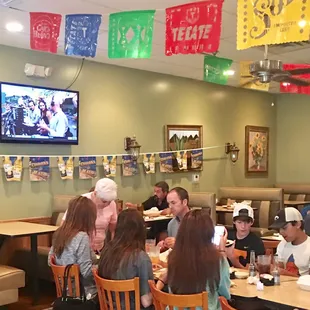 people sitting at tables in a mexican restaurant