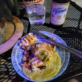 a plate of food and a bottle of beer