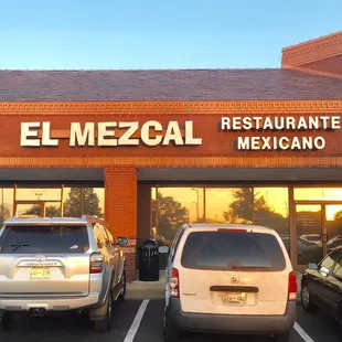 cars parked in front of a restaurant