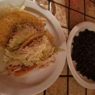 a plate of food and a bowl of beans