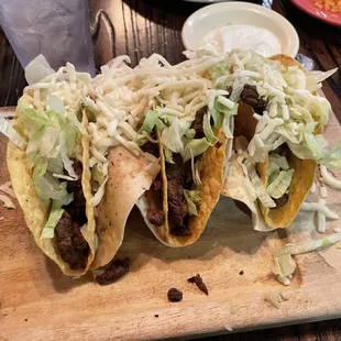 two tacos on a cutting board