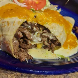 a burrito on a blue plate