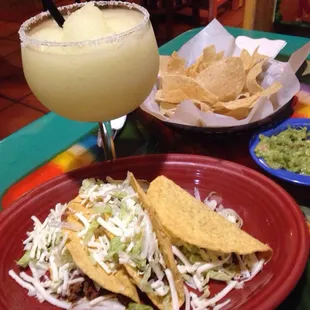 Beef tacos ala carte (3 - $3.99); small guacamole ($3.79);  27 oz margarita ($4.25 on Saturdays) ... WOW!; complimentary chips.