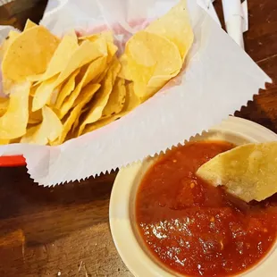 a bowl of chips and a bowl of salsa