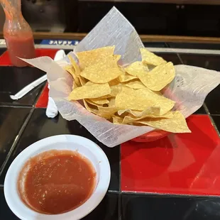 a bowl of chips and a bowl of salsa