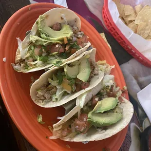 a plate of tacos and chips