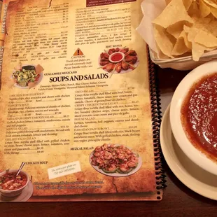 a menu and a bowl of salsa