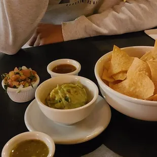 a man eating chips and salsa