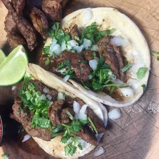 two tacos with meat and onions