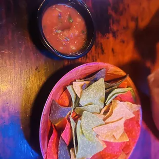 a bowl of chips and a bowl of salsa