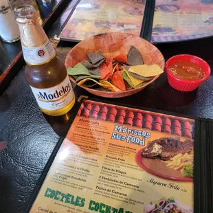 a menu and a bottle of beer