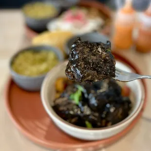 Costillas en Chile Quemado: Pork ribs in adobado sauce, refried black beans, rice, corn tortillas | $20 (SO GOOD!)