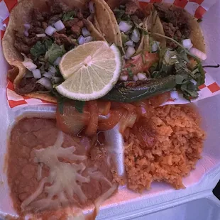 3 taco plate - beef steak on corn tortillas with a side of rice and beans