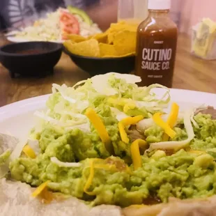 Bean and Cheese Burro with a side of guac. A chicken topopo salad in the background. Both were excellent!