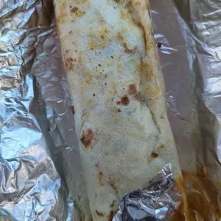 a burrito wrapped in aluminum foil
