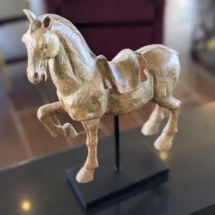 a statue of a horse on a table