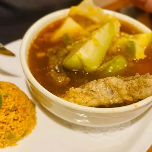 a bowl of soup and a plate of rice