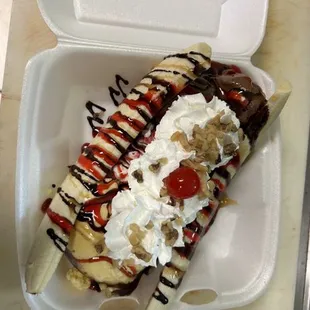 a banana split in a styrofoam container
