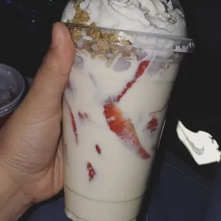 a hand holding a drink