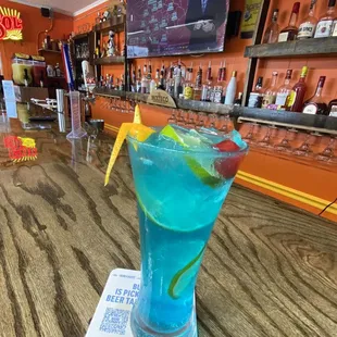 a blue drink on a table