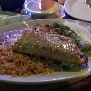 Chunks of beef chimichangas, rice, beans, lettuce, sour cream and guacamole