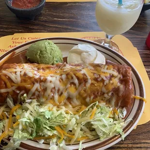 Lunch chimi with chili con carne and the works (enchilada sauce, guacamole and sour cream). House frozen margarita.