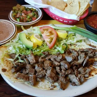 Carne asada soft flower tacos. With beans and rice. Chips and salsa. Mmmmm