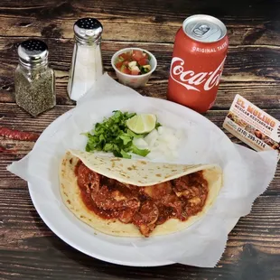 a plate of food and a can of coke