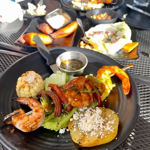 anticucho skewer with shrimp and grilled corn, potato slice, cheese, and chimichurri on the side - $8 during happy hour