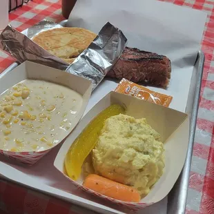 Brisket with potato salad and cream corn. Homemade BBQ sauce.