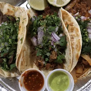 Steak, carnitas, and al pastor tacos. The sauces it came with were surprisingly hot (red and creamy jalapeño)