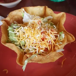 Taco salad, minus cheese sauce with shredded chicken.