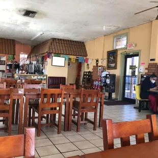 the inside of a restaurant with tables and chairs