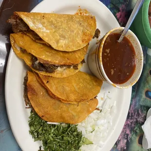 Quesa Birria tacos with consumé.