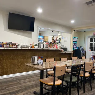 a restaurant with a long table and chairs
