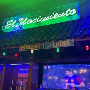 a neon sign above a bar