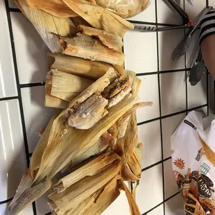 a person cutting corn on a cutting board