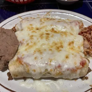 Enchiladas with rice and refried beans